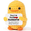 Handmade yellow knitted duck plush toy with an inspirational card
