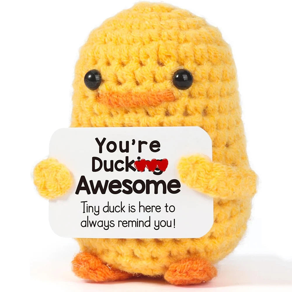 Handmade yellow knitted duck plush toy with an inspirational card