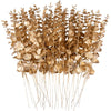 A bundle of dried, golden-brown artificial eucalyptus leaves used for home decor or events.