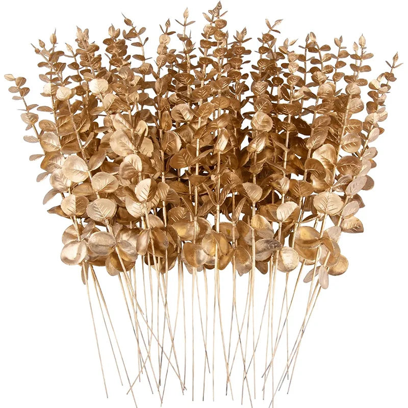 A bundle of dried, golden-brown artificial eucalyptus leaves used for home decor or events.