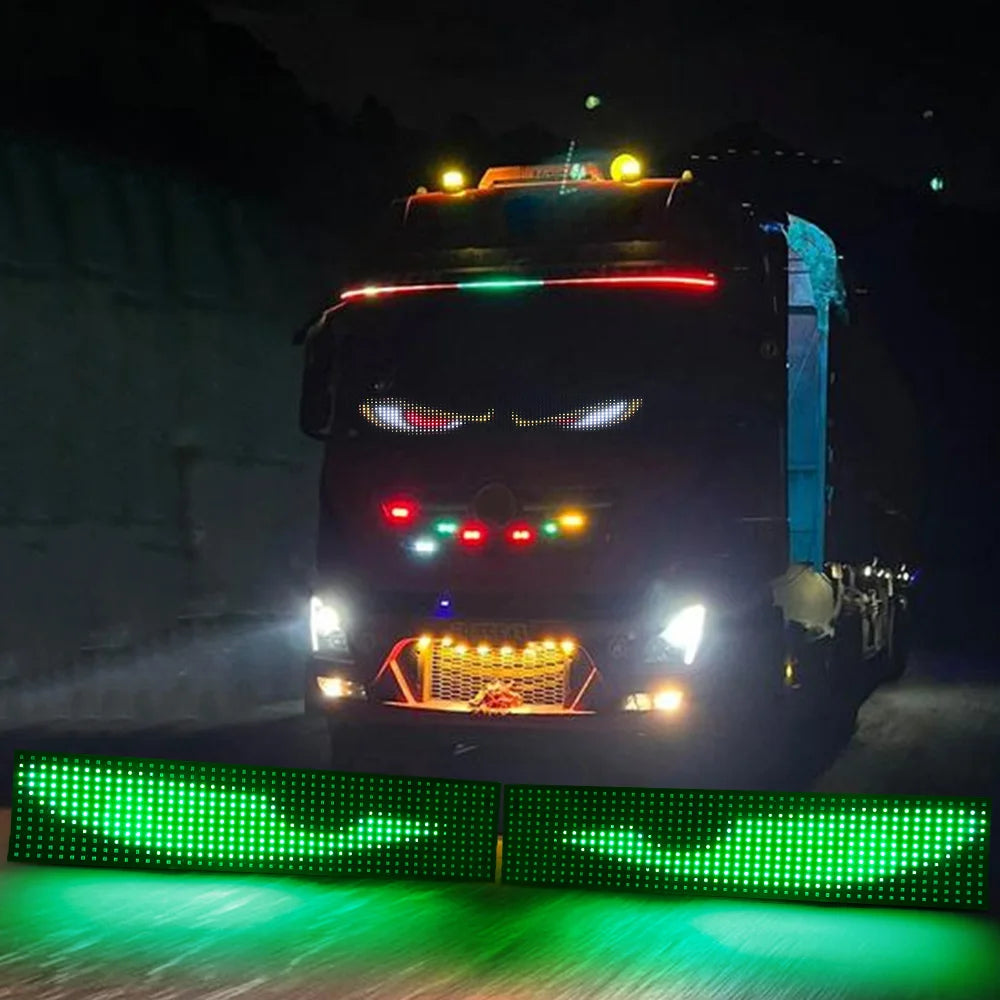A black truck with bright LED lights and a green light effect on the ground.