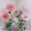 Artificial silk pink poppy flower heads stems and bases displayed against a white background