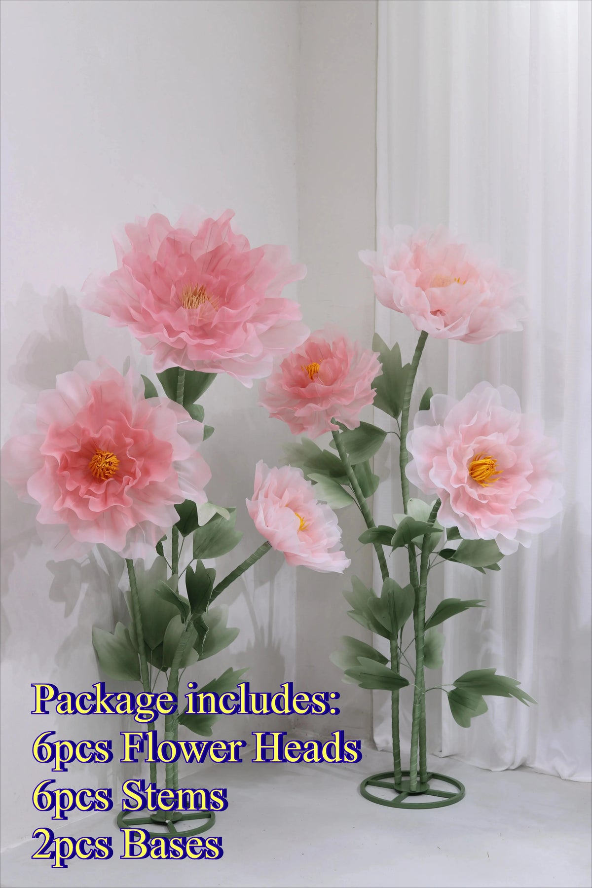 Artificial silk pink poppy flower heads stems and bases displayed against a white background