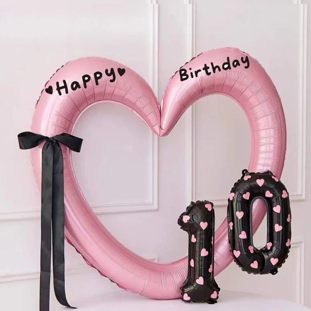 Pink heart-shaped balloon decoration with Happy and Birthday text