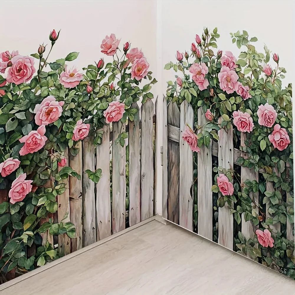 A watercolor floral decal featuring pink roses and green foliage on a weathered wooden fence wall.