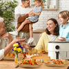 A family is preparing food in a kitchen, with disposable parchment paper liners visible on the counter.