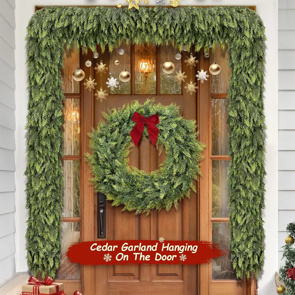 Artificial cedar garland hanging on a wooden door for holiday decoration