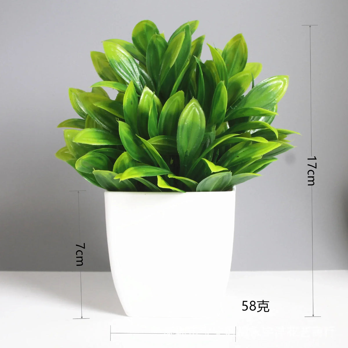 A vibrant green artificial bonsai plant with eucalyptus leaves in a white pot.