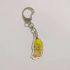 Acrylic keychain featuring a yellow banana cat charm attached to a silver split ring.