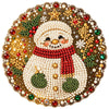 A detailed diamond painting depicting a cute snowman surrounded by festive gold and green elements.