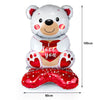 A large white teddy bear balloon with a red heart design and 'love you' text, accompanied by a red heart foot balloon.