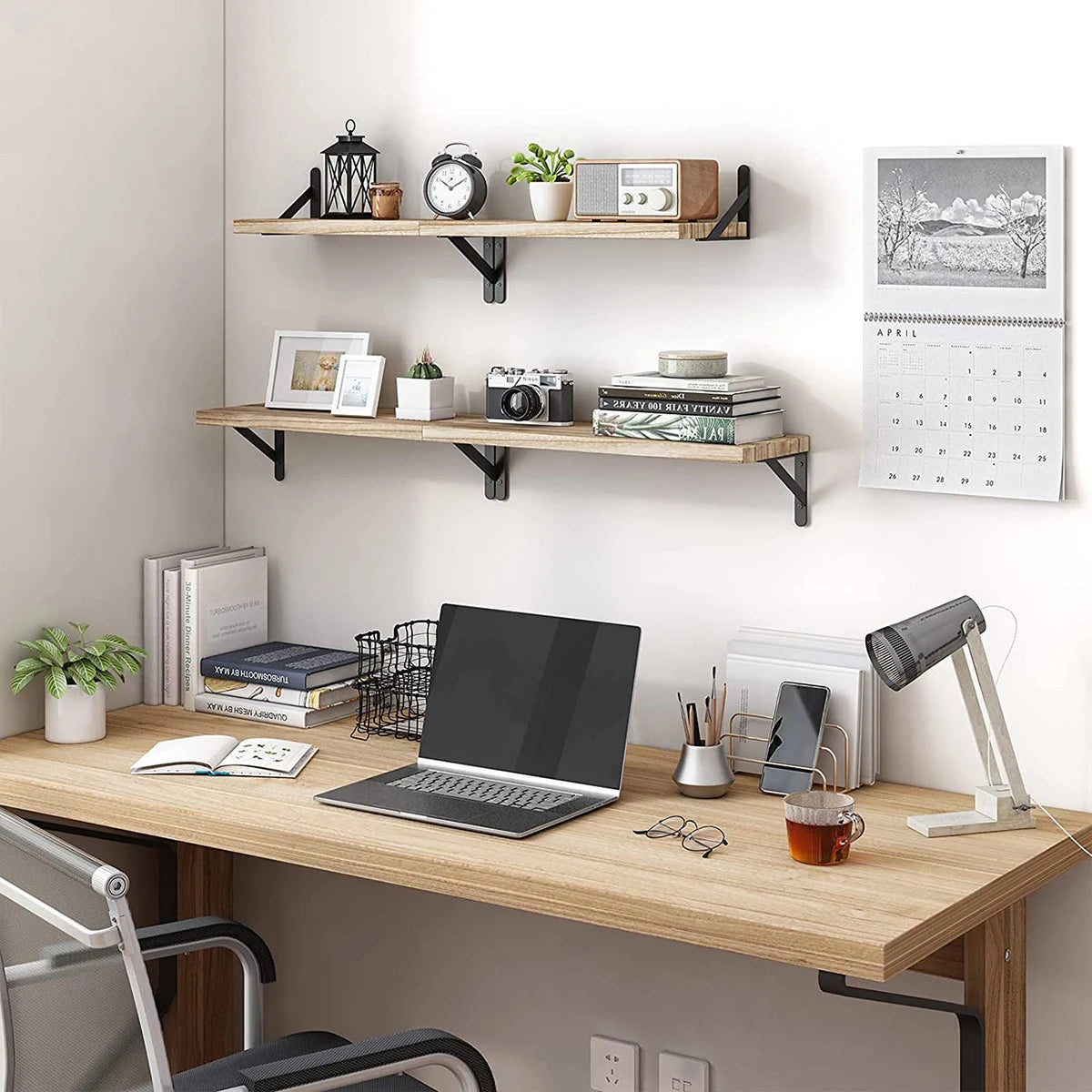 Natural wood floating wall shelves displaying various decorative and office items.