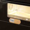 A dishwasher clean or dirty indicator magnet placed on a dark surface.