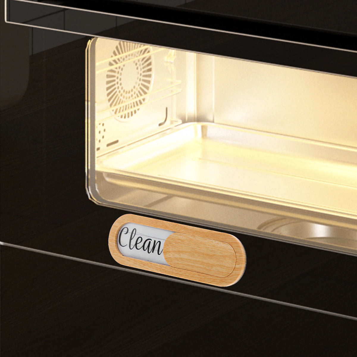 A dishwasher clean or dirty indicator magnet placed on a dark surface.