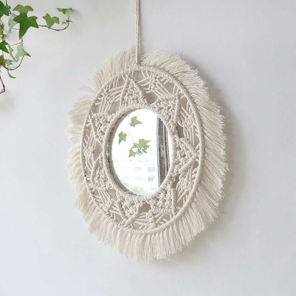 Miroir rond en macramé pour la décoration murale, avec une couronne de fibres naturelles et un miroir accroché sur un mur bla