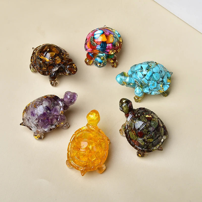 Eine Sammlung farbenfroher Kristall-Schildkrötenfiguren in verschiedenen Schattierungen von grün, lila, blau und gelb.
