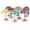 A collection of nine small crystal money trees with colorful foliage mounted on copper wire stems and green bases.
