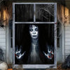 A dark portrait of a woman with white face paint and long black hair is displayed through a window decorated with bare branch
