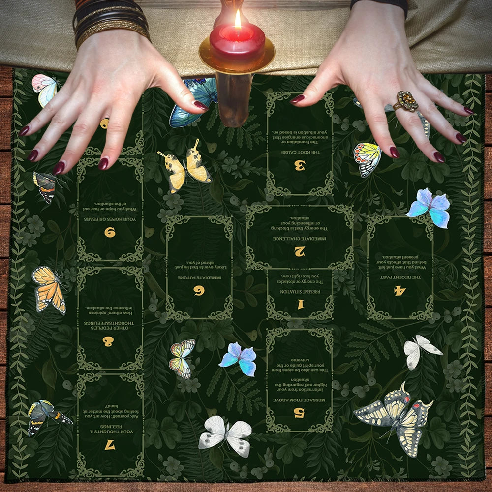 A dark green altar cloth featuring various tarot and divination symbols, including butterflies and other mystical elements.