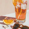 A glass of orange juice with ice and a lemon slice sits on a white surface.