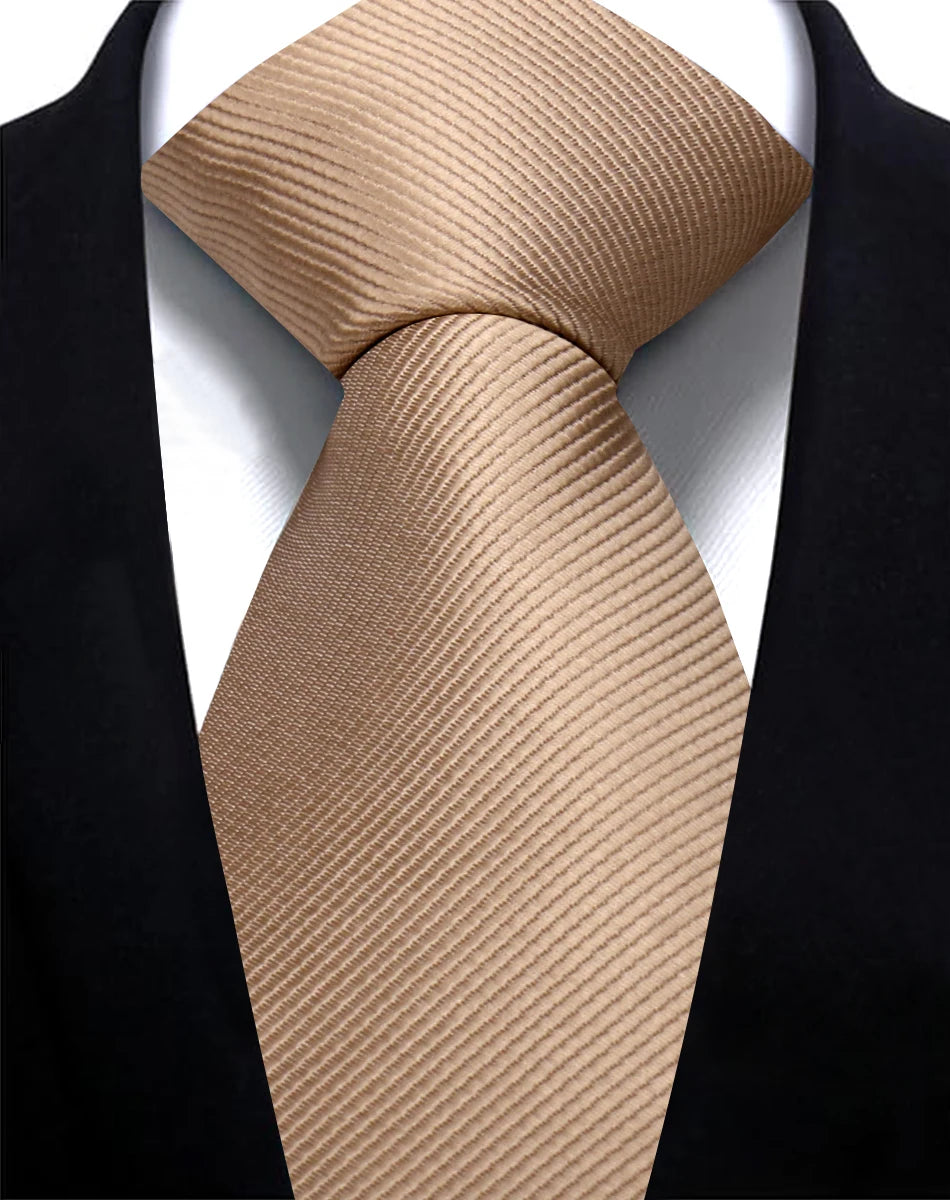 A beige striped silk necktie tied in a knot against a black suit jacket.
