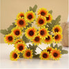 A bouquet of three lifelike silk gerbera daisy artificial flowers in vibrant yellow and orange tones.