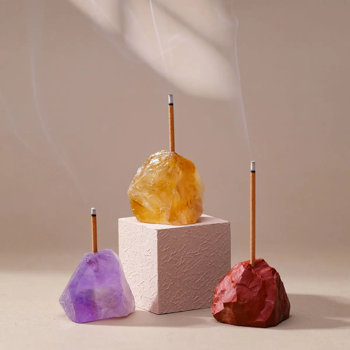 A display of natural amethyst and clear quartz crystals used as an aromatherapy holder for incense.