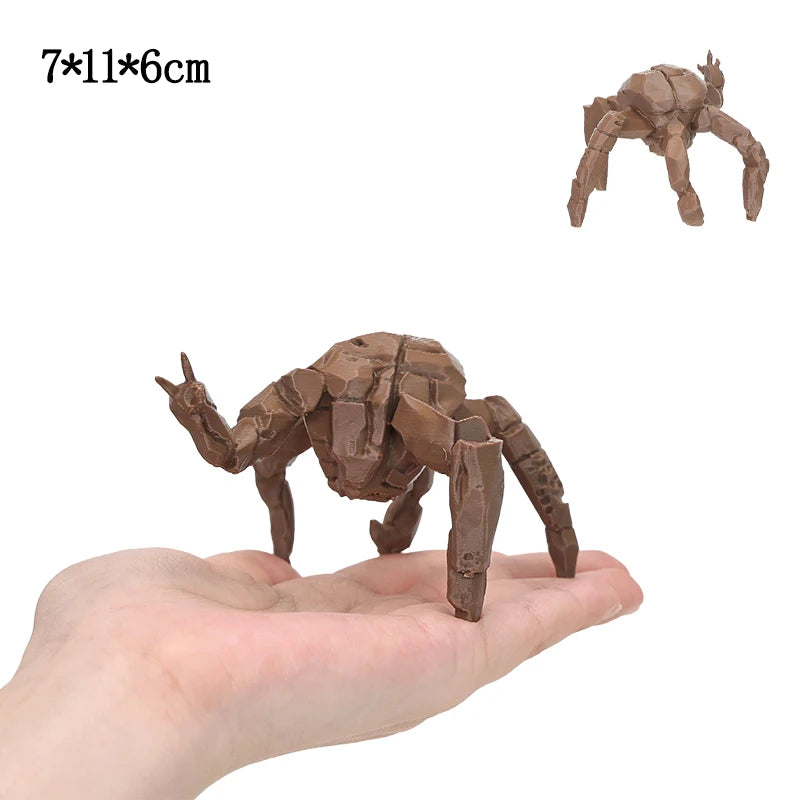 A brown collectible figurine set of Rocky and Grace, shaped like a creature, is held in a person's hand.