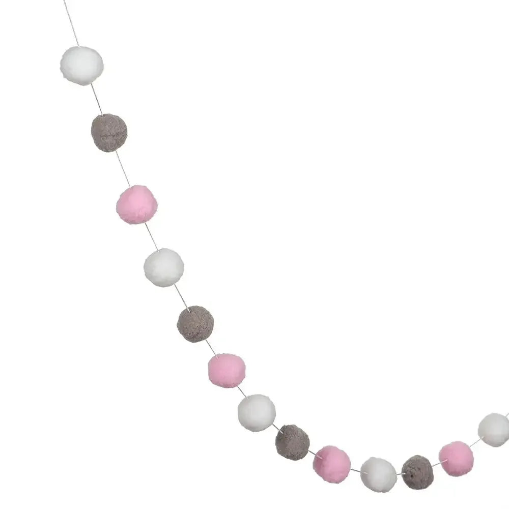 A string of colorful felt balls in white, gray, and pink creating a decorative garland.