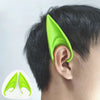 A close-up of a person's ear with a realistic green latex elf ear placed on it, next to a diagram of the ear shape.