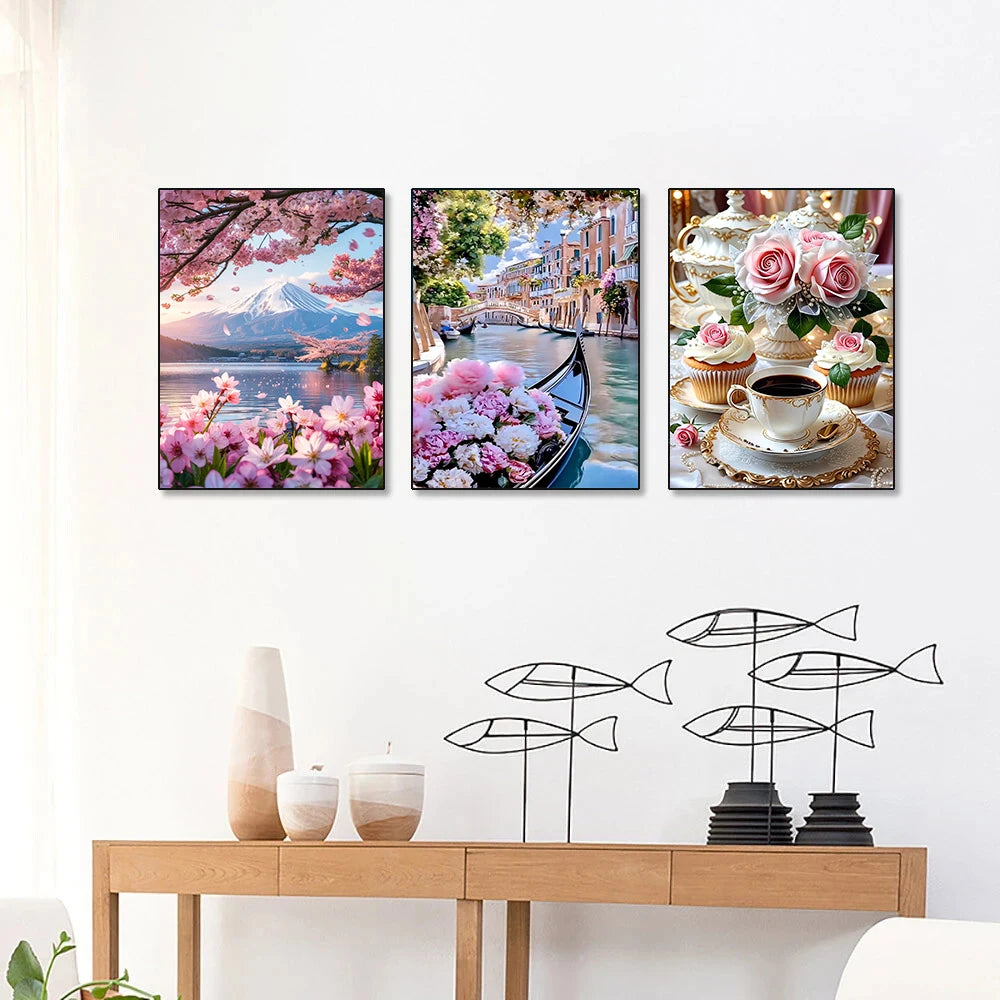 Three diamond painting panels featuring scenic views of mountains, cherry blossoms, and European architecture.