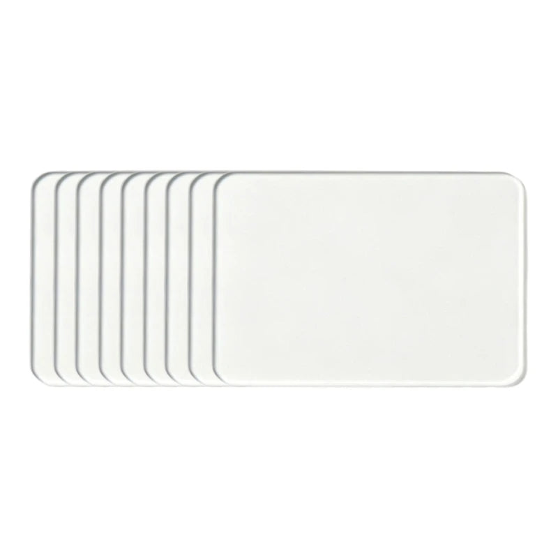 A set of white acrylic fridge magnets with flexible magnetic backing.