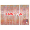 Metallic foil fringe curtains in shades of pink and gold creating a shimmering backdrop.