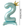 A large, light blue foil number balloon shaped like the number 2 with a gold crown topper.