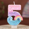Rainbow sequined number candles shaped like the number 5 in pink, purple, and blue.