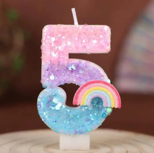 Rainbow sequined number candles shaped like the number 5 in pink, purple, and blue.