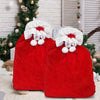Festive red velvet Santa Claus gift bags with white trim and pom-poms