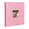 A pink linen front scrapbook memory book with a photo of a family.