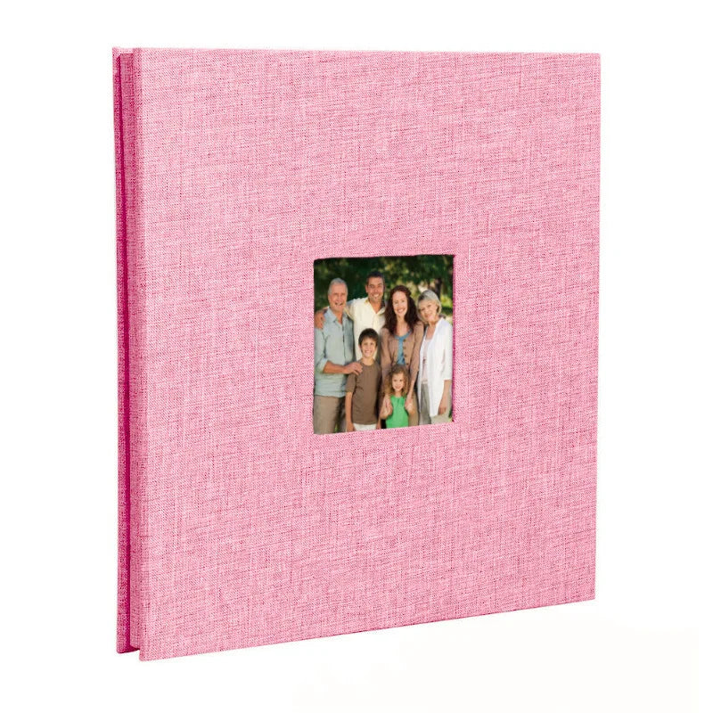 A pink linen front scrapbook memory book with a photo of a family.