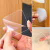 Hand holding a clear double-sided adhesive tape, showing its transparent and flexible nature.