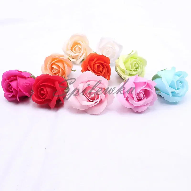 A collection of artificial rose flower heads in various shades of peach, orange, pink, and green.