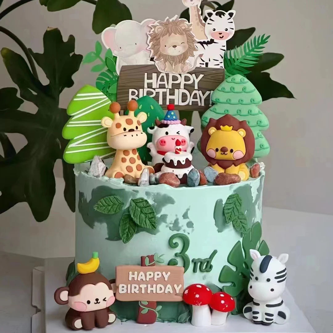 A tiered cake decorated with jungle animal toppers including a giraffe, lion, and tiger, set against green foliage.