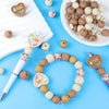 A collection of natural silicone beads in various colors and sizes arranged on a white surface and a blue background.