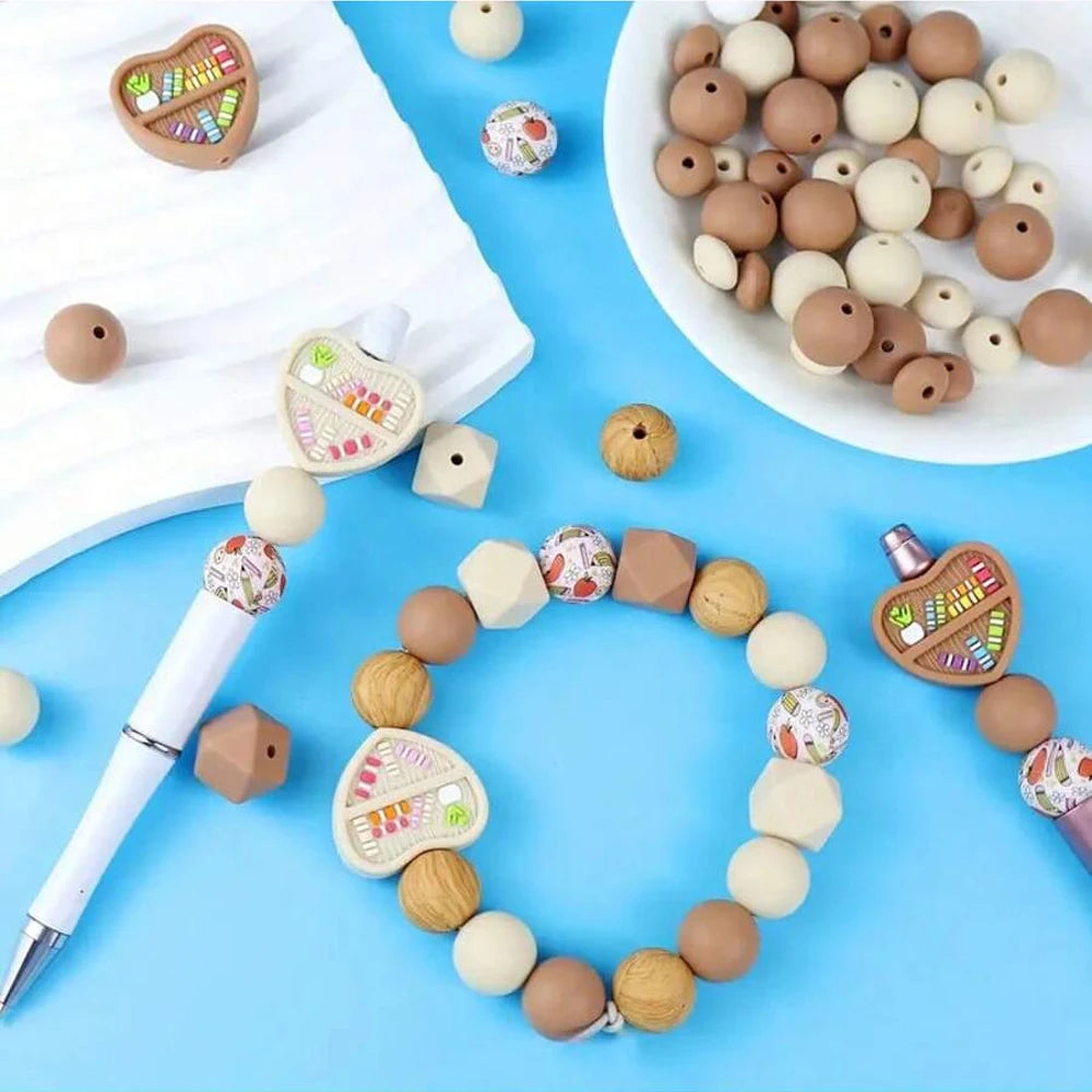 A collection of natural silicone beads in various colors and sizes arranged on a white surface and a blue background.