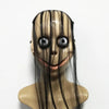 A realistic horror animal mask with dark hair and a wide, smiling expression.