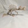 A white 3D printed figurine of a dinosaur skeleton, featuring a T-Rex and Mosasaurus skull.