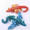 A pair of 3D printed magic dragon desktop ornaments, one gold and one blue, displayed against a white background.