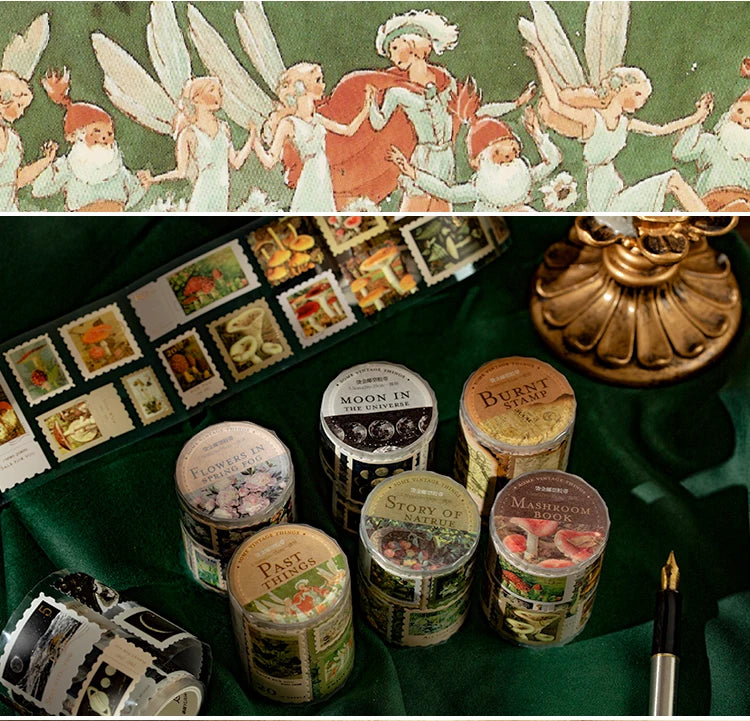 A collection of decorative washi tape rolls and a green fabric featuring winged figures.