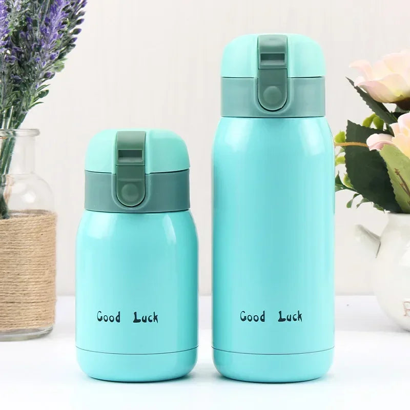 A light blue vacuum insulated coffee mug with a silver lid is shown next to some lavender and roses.