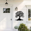 Black silhouette of a large tree with roots on white siding next to a white door and window